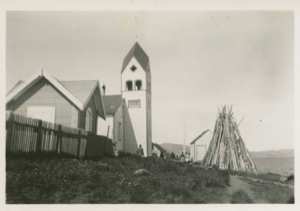 Image: Church and stack of wood for winter